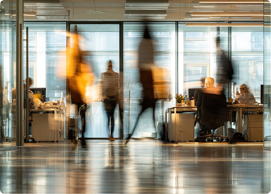 Employees working in a modern office, illustrating collaboration and strategic planning around full-service logistics for mid-sized businesses.